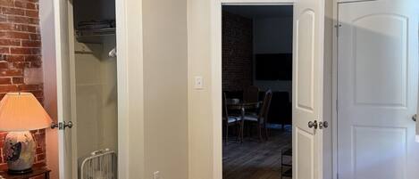 A bedroom with a bed, a ceiling fan, a lamp, and a radiator.