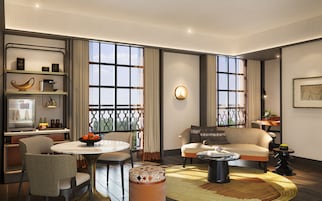 Una sala de estar moderna con una mesa de comedor redonda, un sofá y una mesa de centro.
