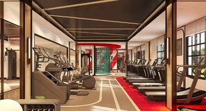 Un gimnasio con cintas de correr, elípticas y equipo de pesas.