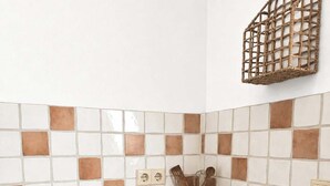 A kitchen with a stainless steel sink, wooden cabinets, a white countertop, and a mosaic tile backsplash. - Alpine Retreat: Pet-Friendly Apartment w/ Free (Fischbachau)