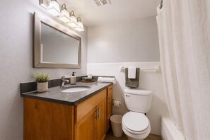 Ein Badezimmer mit Waschbecken, Spiegel und Toilette.