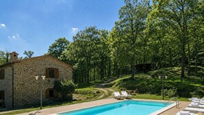 A stone building with a swimming pool, surrounded by trees and a grassy area. - Exclusive Holiday Villa With Private Pool Between Marche and Umbria (Apecchio)
