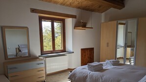 A bedroom with a bed, a dresser, a mirror, a window, and a wardrobe. - Exclusive Holiday Villa With Private Pool Between Marche and Umbria (Apecchio)