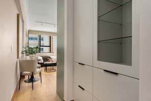 A modern interior with a sofa, dining table, and a potted plant. - Charlie and the Chairman | Stylish Studio (Cape Town)
