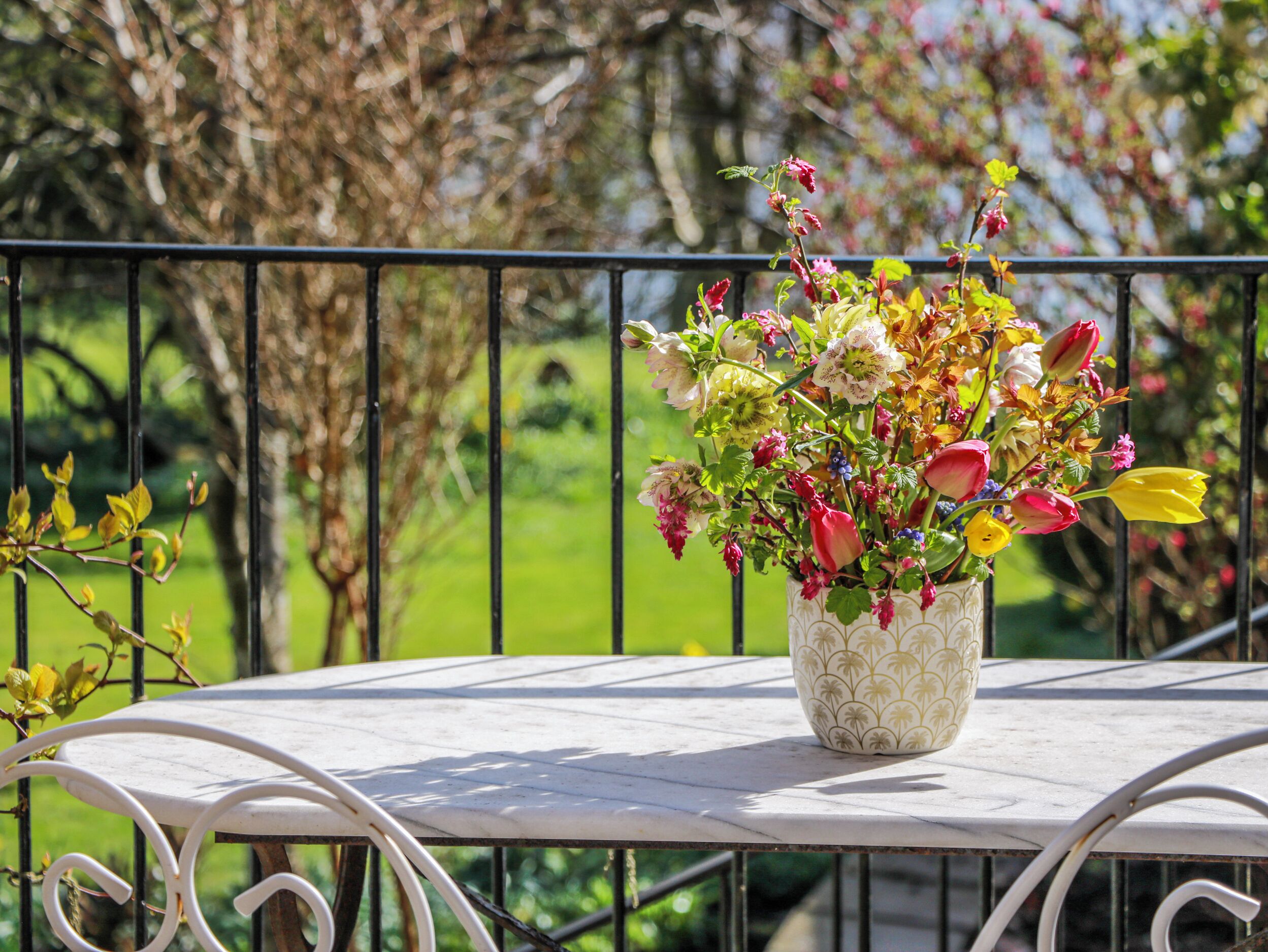 A white table with a floral arrangement on top.