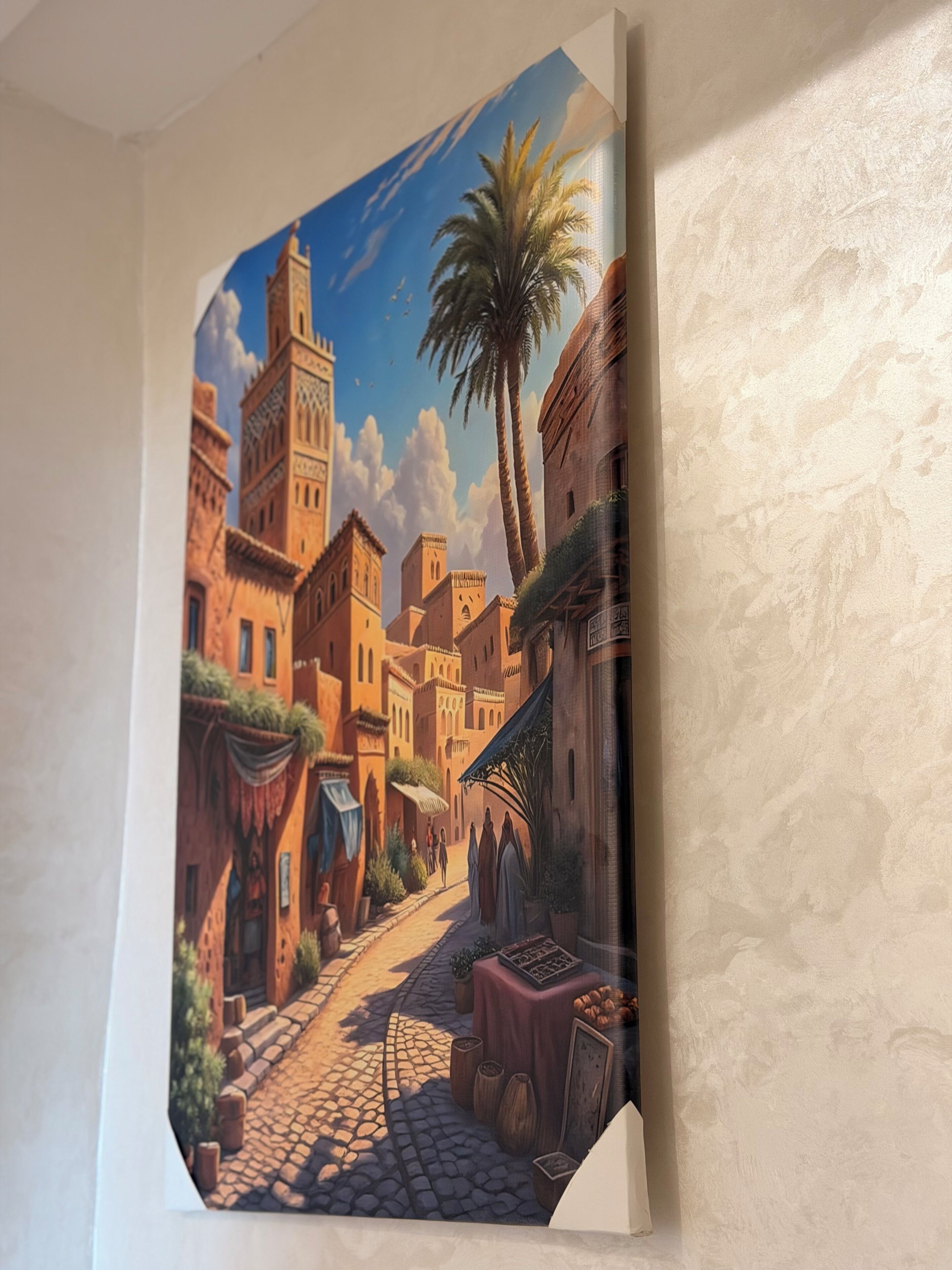 A detailed mural of a traditional street scene with buildings, a palm tree, and a cobblestone path.