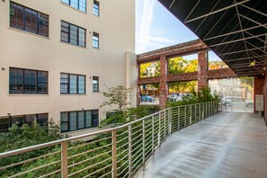 A multi-story building with large windows, a covered walkway, and a view of the street below. - Stylish Loft on South Gay | Downtown Knoxville (Knoxville)