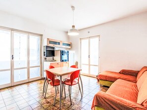 A compact living space with a kitchenette, dining area, and seating area. - La Caracola by Interhome (Marina di Andora)