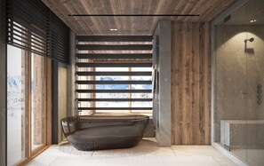 Ein modernes Badezimmer mit einer großen Badewanne, Holzlamellen und Blick auf schneebedeckte Berge.