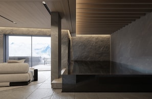 Ein modernes Interieur mit einem großen Fenster, einem Kamin und einer Sitzecke.