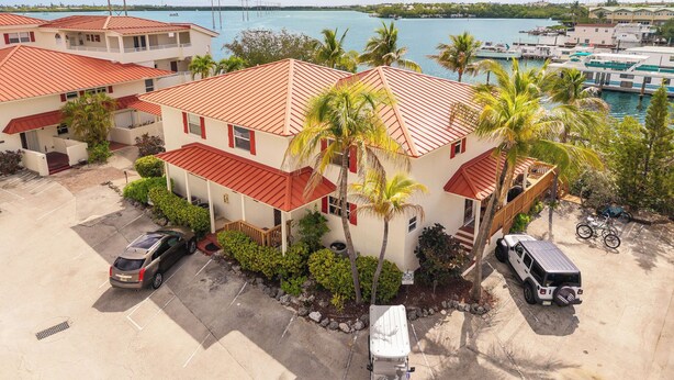 A coastal hotel with red-roofed buildings, a marina, and a clear view of the sea. - SALTWATER SOUL - 2 Bedroom / 2.5 Bathroom Waterfront Townhome W/ Shared Pool (Key West)