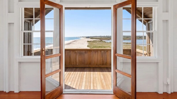 An open wooden door leading to a balcony with a view of a beach and ocean. - Oceana: Beachfront Estate, Period Charm, Sleeps 8 (South Kingstown)