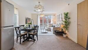 A modern apartment with a dining area, kitchen, living room, and a balcony. - Relocation | Coventry | Early Booking Discount (Coventry)