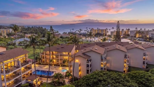 A resort with multiple buildings, a swimming pool, and a view of the ocean. - Surf Rider, Newly Remodeled, Walk Out Lanai, Ocean View, 2ACs, 350Steps to Kam 1 (Kihei)