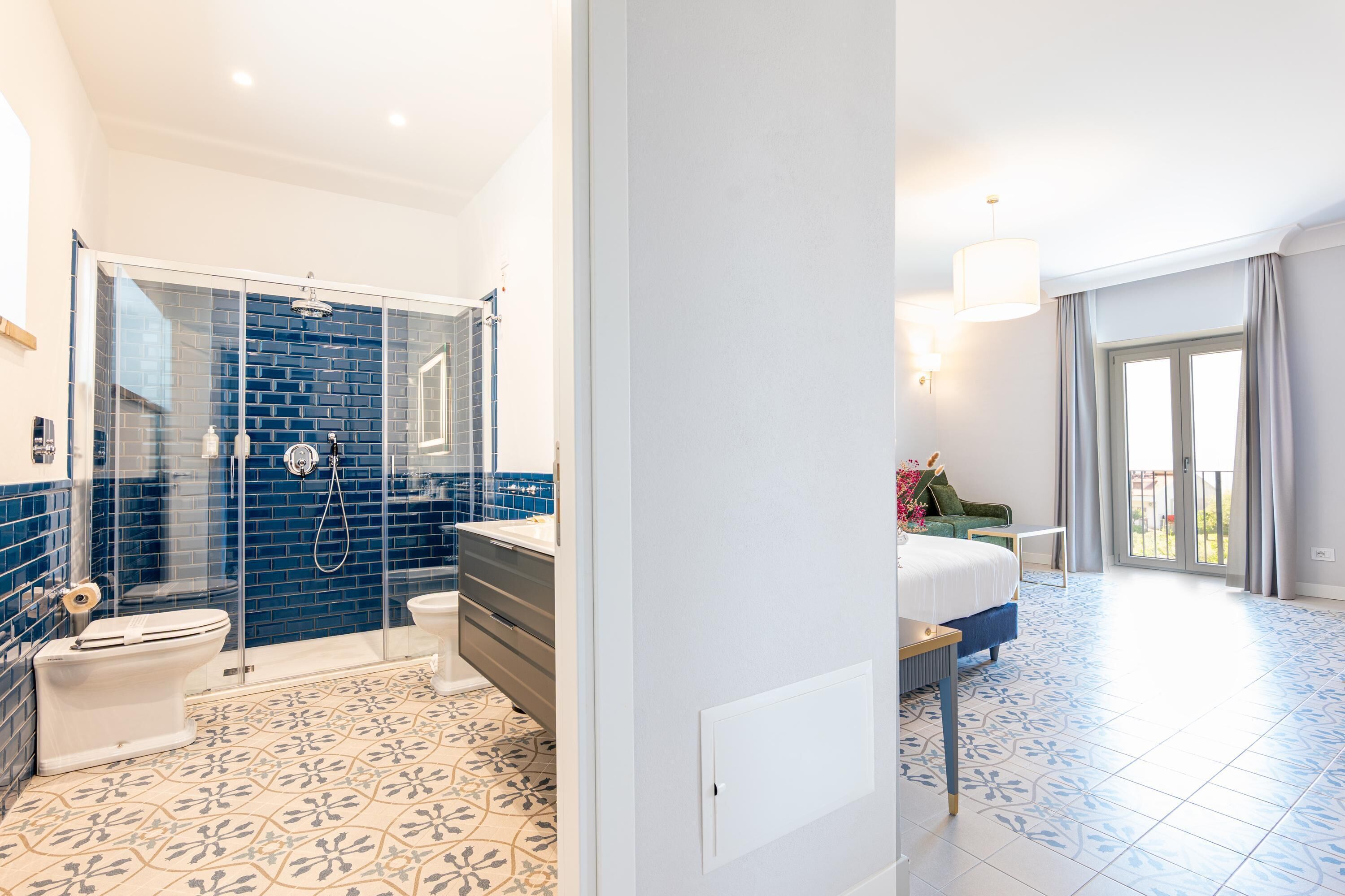 A modern bathroom with a glass shower enclosure, a toilet, and a sink.