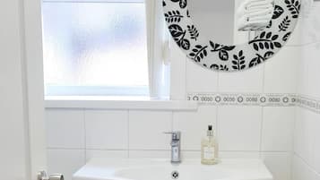 Combined shower/bathtub, deep-soaking bathtub, towels