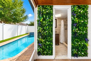 Convenient outdoor bathroom located just steps from the pool and patio area, offering easy access for guests enjoying the backyard amenities. - Private Pool Retreat in Tampa | 5BR/5BA Vacation Home (Tampa)