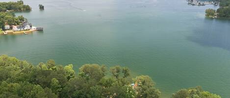 A large body of water with several islands, surrounded by dense forest.