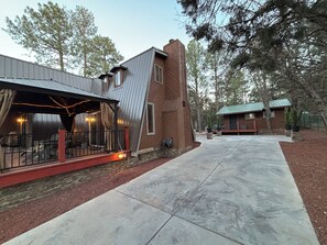 A modern building with a patio area, a covered seating section, and a small adjacent structure. - Chalet Getaway in Beautiful Show Low Arizona (Show Low)