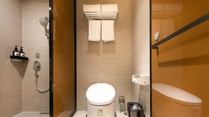 A modern bathroom with a glass shower enclosure, a toilet, and a towel rack. - Ji Hotel (Nanjing)