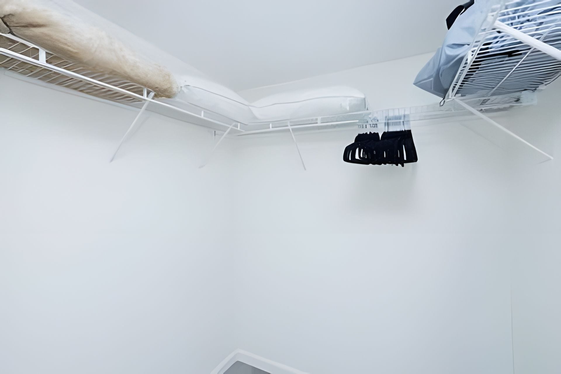 A white room with a bunk bed, a white mattress, and a white ceiling.