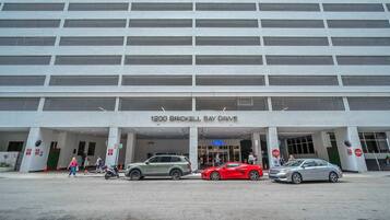 A multi-story building with a large entrance labeled '1200 Brickell Bay Drive.'