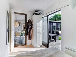 A narrow hallway leading to a dining area with a view of the outdoors. - 4 Star Holiday Home in Dronningmolle (Dronningmolle)
