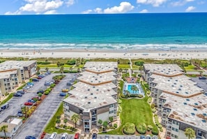 A beachfront hotel with multiple buildings, a parking lot, and a pool area. - Ocean Forest Villas B112 (Myrtle Beach)