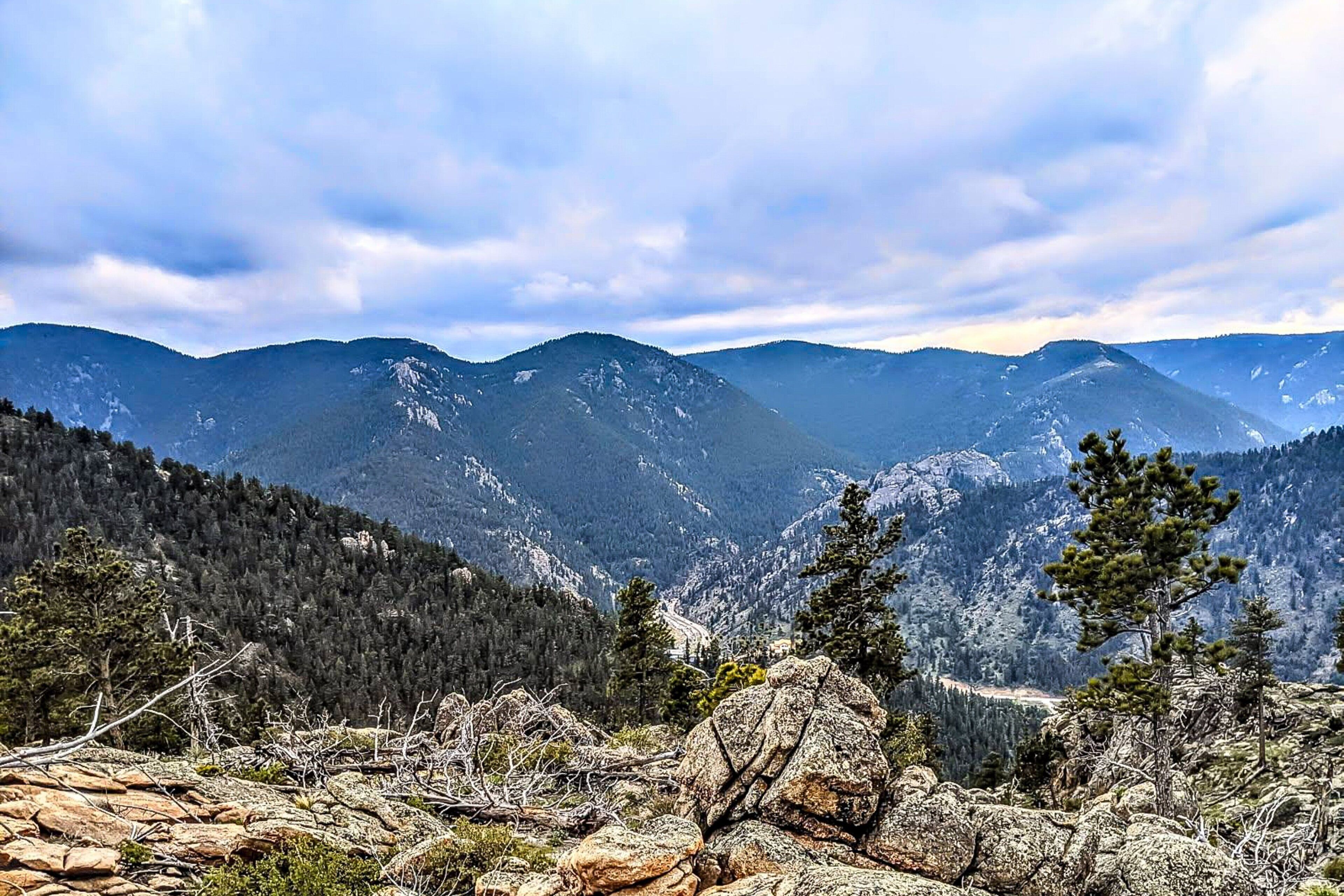 A mountainous landscape with rocky terrain and sparse vegetation.