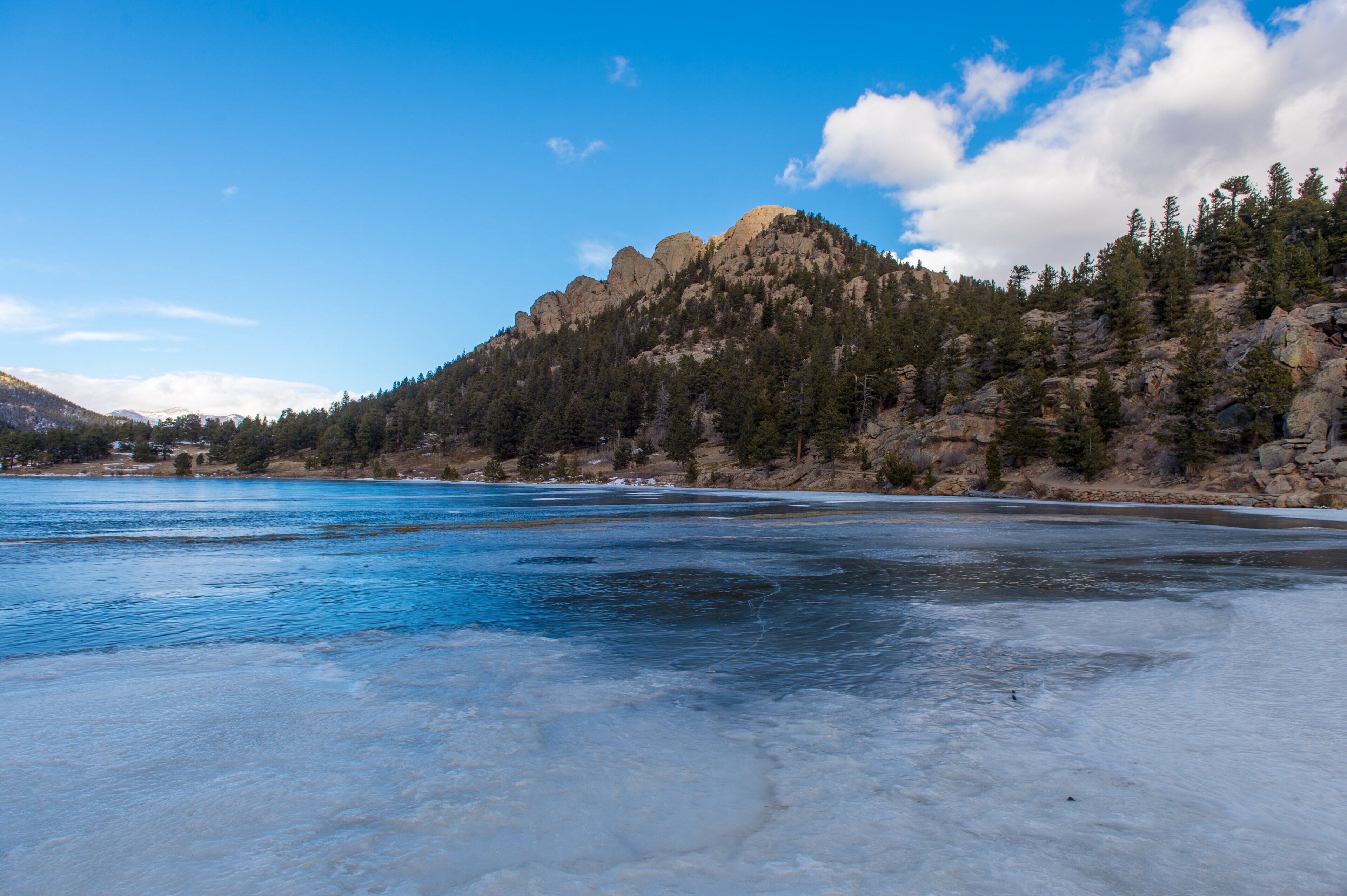 A frozen lake with a mountain in the background.