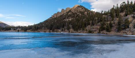 A frozen lake with a mountain in the background.