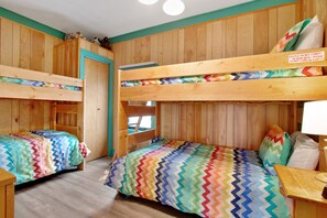 A room with two bunk beds, wooden walls, a window, and a door. - Charming Cabin With Full Kitchen, Furnished Deck, & Incredible Views (Estes Park)