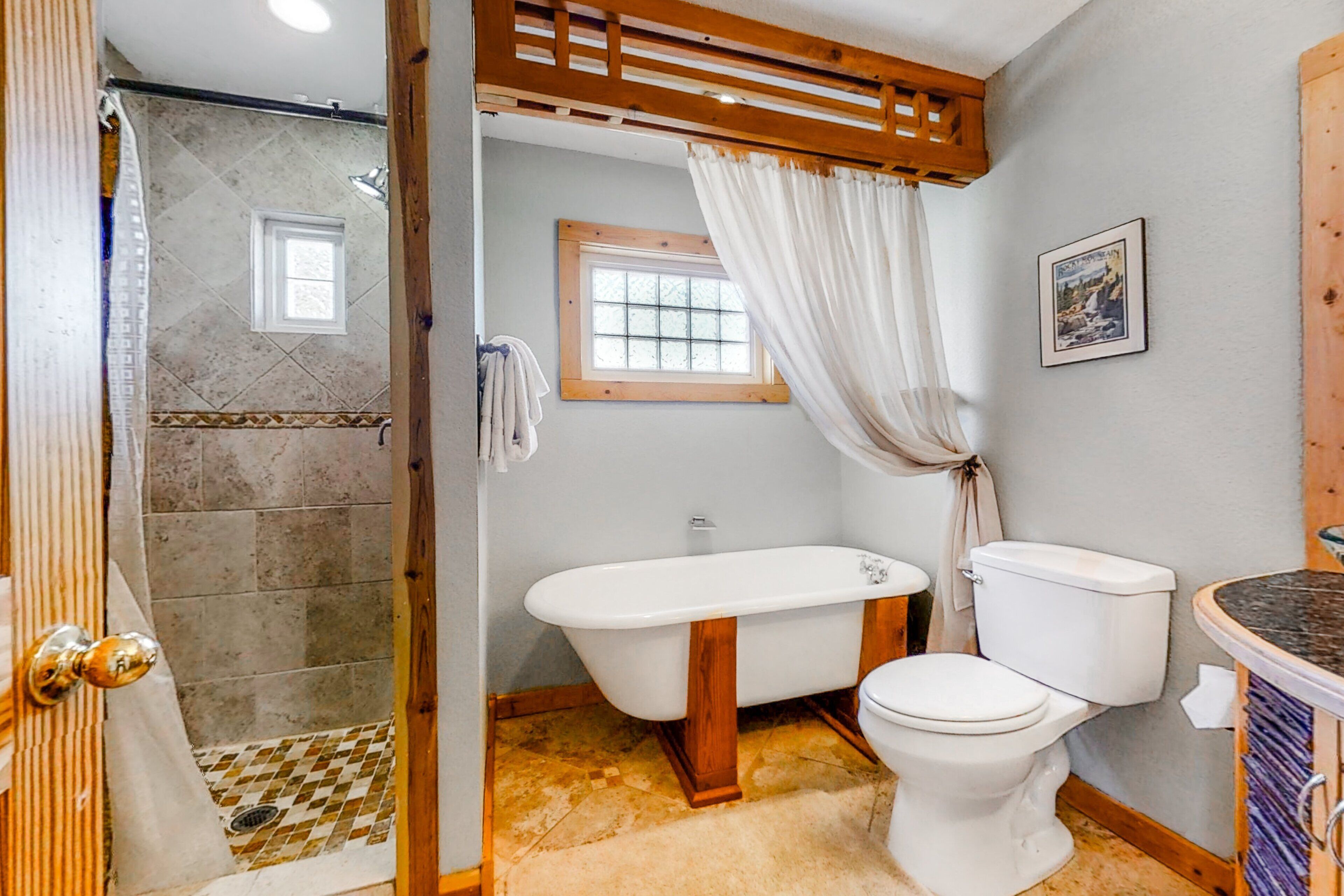 Un baño con ducha, bañera, inodoro y ventana.