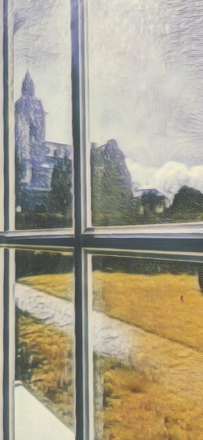 A painting of a landscape viewed through a window with a view of a building and mountains. - Coach house at the Amber Castle (Kuhlen-Wendorf)