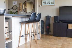 Eine moderne Küche mit Barbereich, einem großen Spiegel und einem Fernseher.