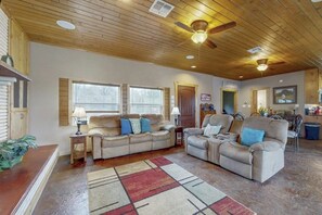 A spacious living room with two sofas, a coffee table, and a fireplace. - Renovated Waterfront Home With Wifi, Lake Views, Dock & Boat Lift - Dogs OK (Burnet)