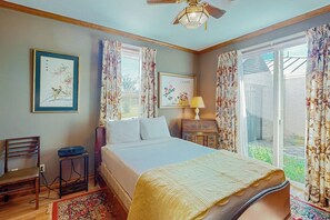 A bedroom with a bed, a chair, a small table, a lamp, and a ceiling fan. - 2-story Home With Covered Patio, Balcony, Fireplace, Streaming, Great Views, W/D (Kerrville)