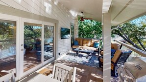 A covered patio with a seating area, a grill, and a view of the outdoors. - Waterfront, Dog-friendly Home With Lake Views, Private Boat Lift & Dock (Horseshoe Bay)