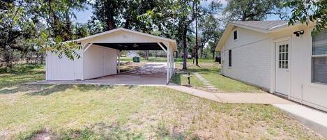 A single-story building with a covered garage and a detached garage.