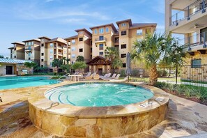 A hotel with a swimming pool, lounge chairs, and a hot tub. - Stunning Lakefront Home on Lake LBJ With Private Balconies - Close to Yacht Club (Horseshoe Bay)