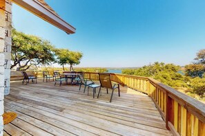 A wooden deck with outdoor furniture and a view of a body of water. - Lovely 2-story Home With Upper & Lower Decks, Gorgeous Lake & Hill Country Views (Buchanan Dam)