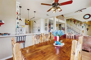 A spacious kitchen with wooden cabinets, a dining area with a wooden table and chairs, and a staircase leading to an upper level. - Waterfront Home With Kayak, View, Fire Pit & Wifi - Dog-friendly (Buchanan Dam)