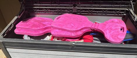 A storage box with pink items inside.
