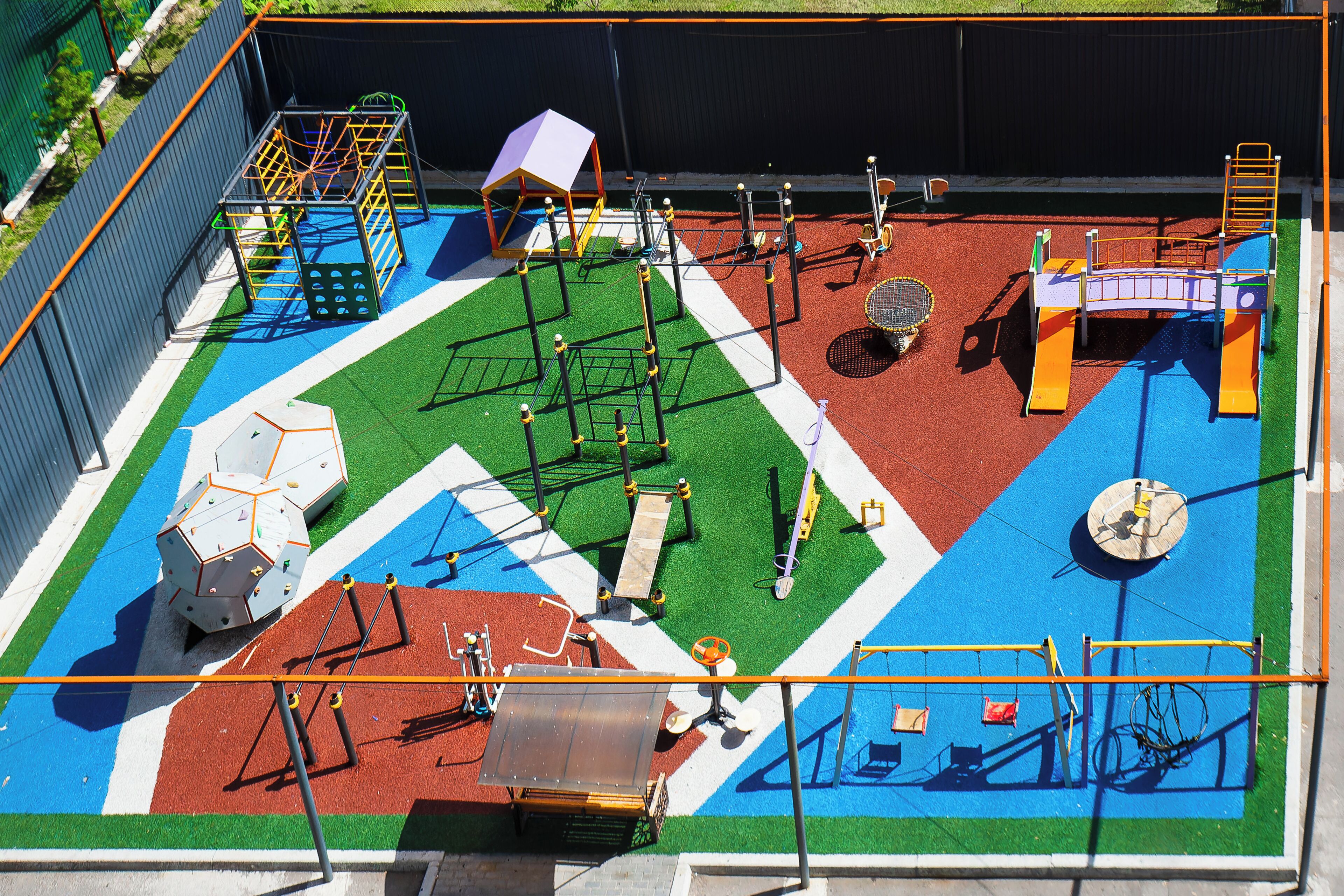 A playground with various play structures and equipment.