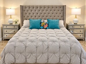 A bedroom with a tufted headboard, a large bed with a quilted duvet, two bedside tables with lamps, and decorative pillows. - Premier 3-Bedroom Condo in Coveted Indian Wells Country Club, Discounted Rates! (Indian Wells)