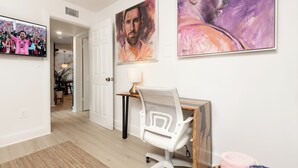A modern room with a desk, chair, and artwork on the wall. - "Boutique Art Home"  Little Havana King Bed,Near Brickell,Airport & South Beach (Miami)