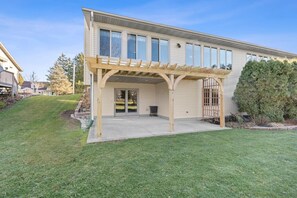 A two-story house with a covered patio and a garage. - Sunset Vista- cozy two bedroom retreat (Sheboygan)