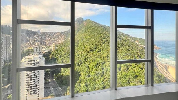 A room with large windows offering a view of a cityscape, a mountain, and a beach. - Private room at Hotel Nacional, Rio de Janeiro, Brazil (Rio de Janeiro)