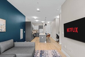 Eine moderne Wohnung mit Wohnzimmer, Küche und Essbereich.