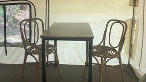 Una tenda con un tavolo e due sedie.